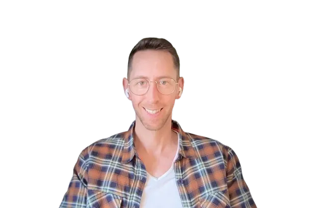 Smiling man wearing round glasses, white earbuds, white t-shirt, and brown plaid shirt.